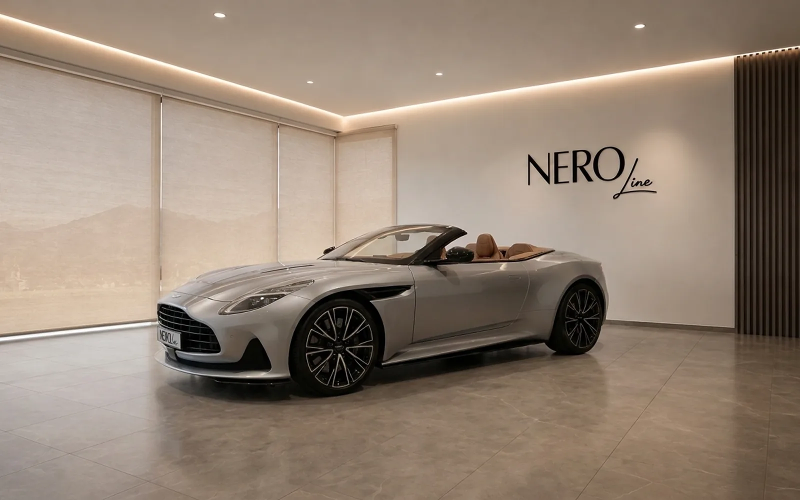Aston Martin DB12 Volante — Luxury convertible in Lausanne The metallic silver Aston Martin DB12 Volante, with its elegant brown leather interior, is showcased indoors in Lausanne.