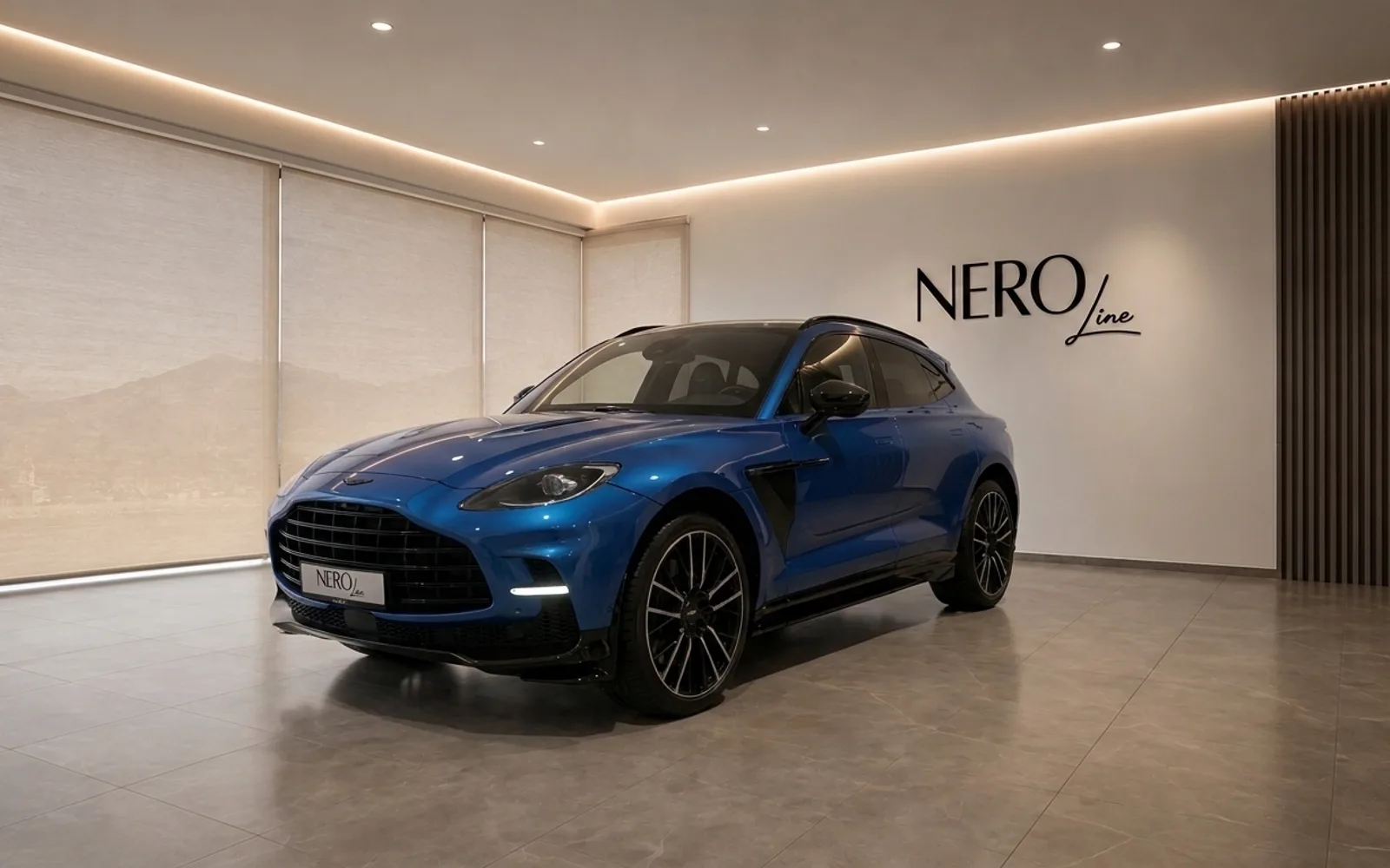 Aston Martin DBX707 — Front three-quarter view in Lausanne The blue Aston Martin DBX707 is parked in a modern showroom in Lausanne, showcasing its elegant front three-quarter view.