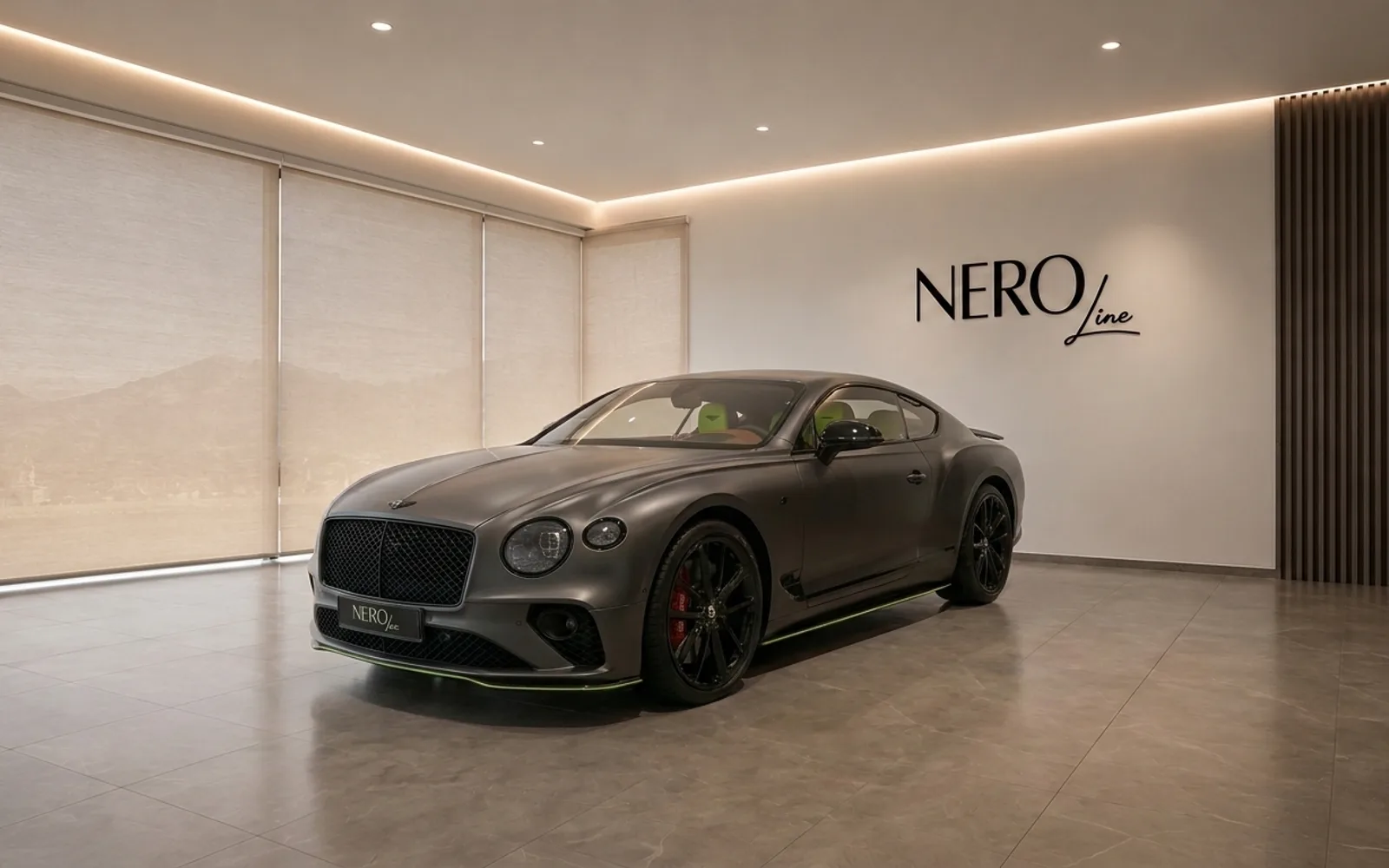 Bentley Continental GT — Showroom view Lausanne The 2022 Bentley Continental GT in Satin Anthracite Grey, showcasing its front three-quarter view in a modern Lausanne showroom.