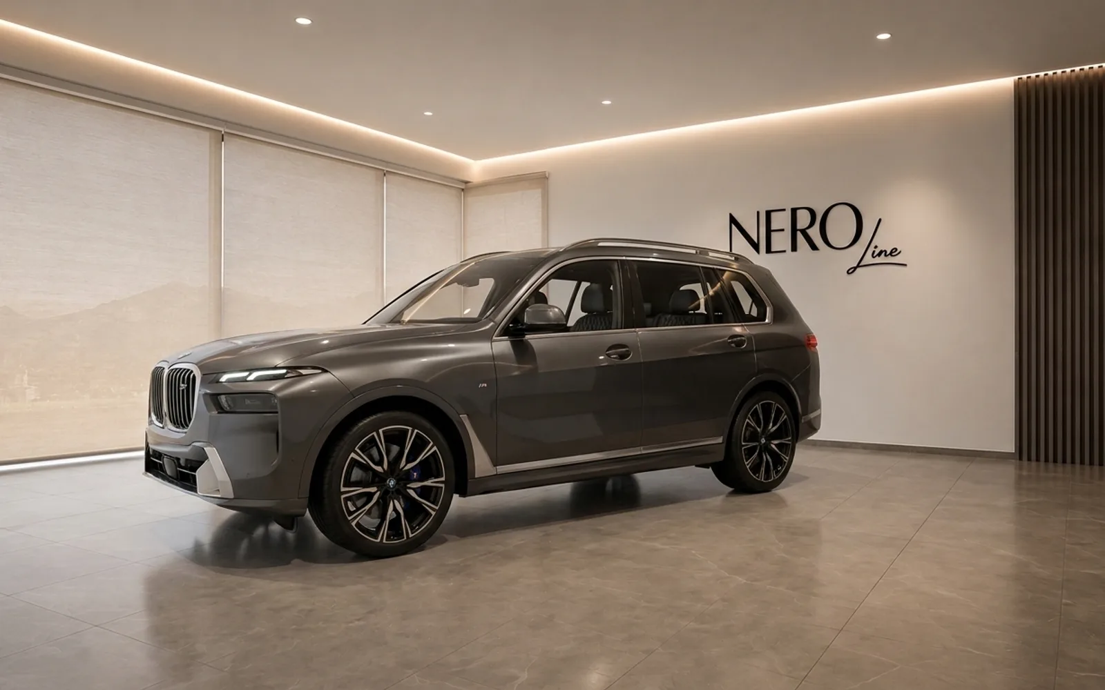 BMW X7 — Front three-quarter view in Lausanne The metallic dark grey 2023 BMW X7 is parked in a modern showroom in Lausanne, seen from a front three-quarter angle.