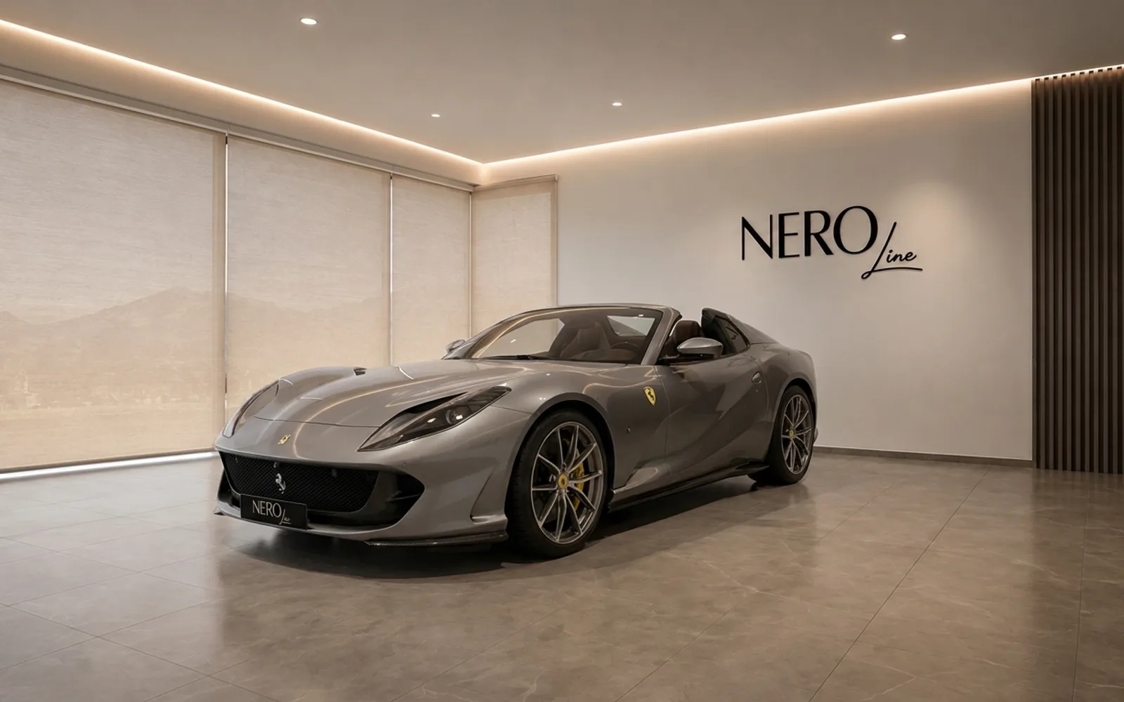 Ferrari 812 GTS — Showroom display in Lausanne The grey Ferrari 812 GTS convertible is showcased in a modern showroom with the NEROline logo in Lausanne.
