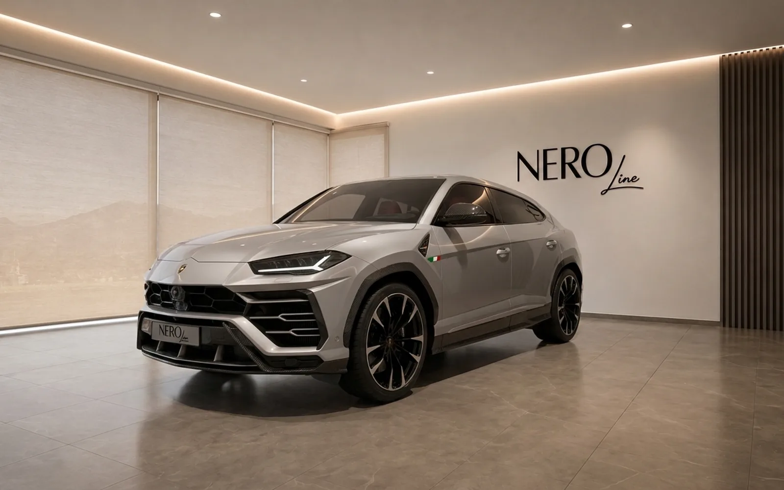 Lamborghini Urus — Front three-quarter view Zurich The silver Lamborghini Urus is showcased from a front three-quarter angle in a modern NEROline showroom in Zurich.