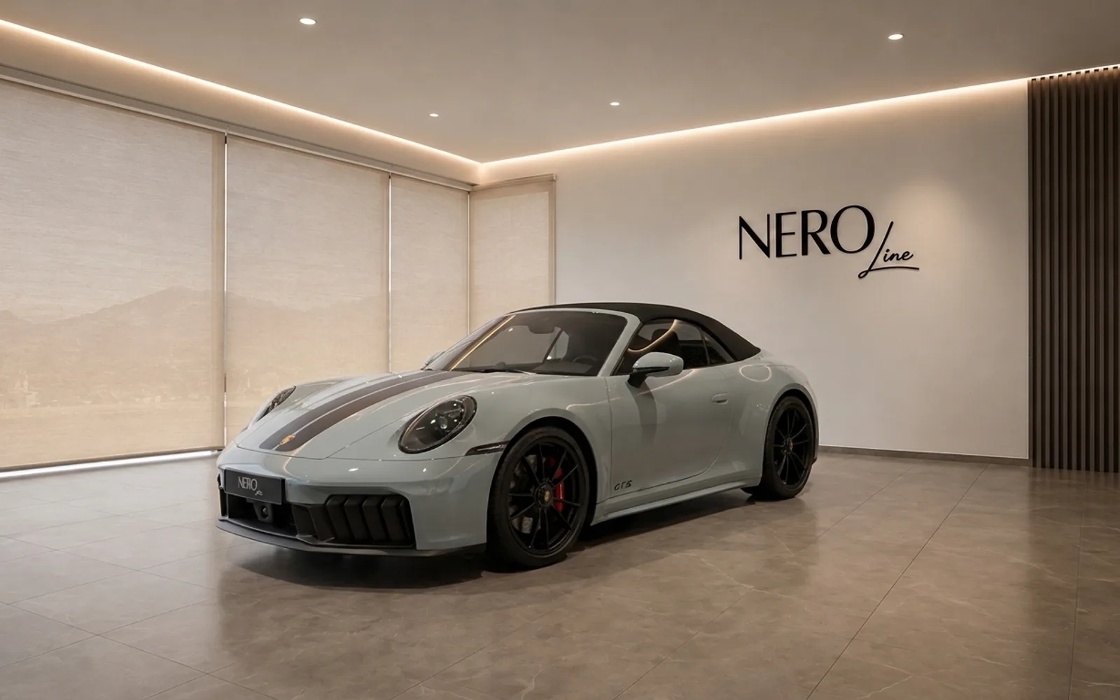 The gloss light grey Porsche 911 Carrera 4 GTS Cabriolet is showcased from the front three-quarter view in a showroom in Zurich.