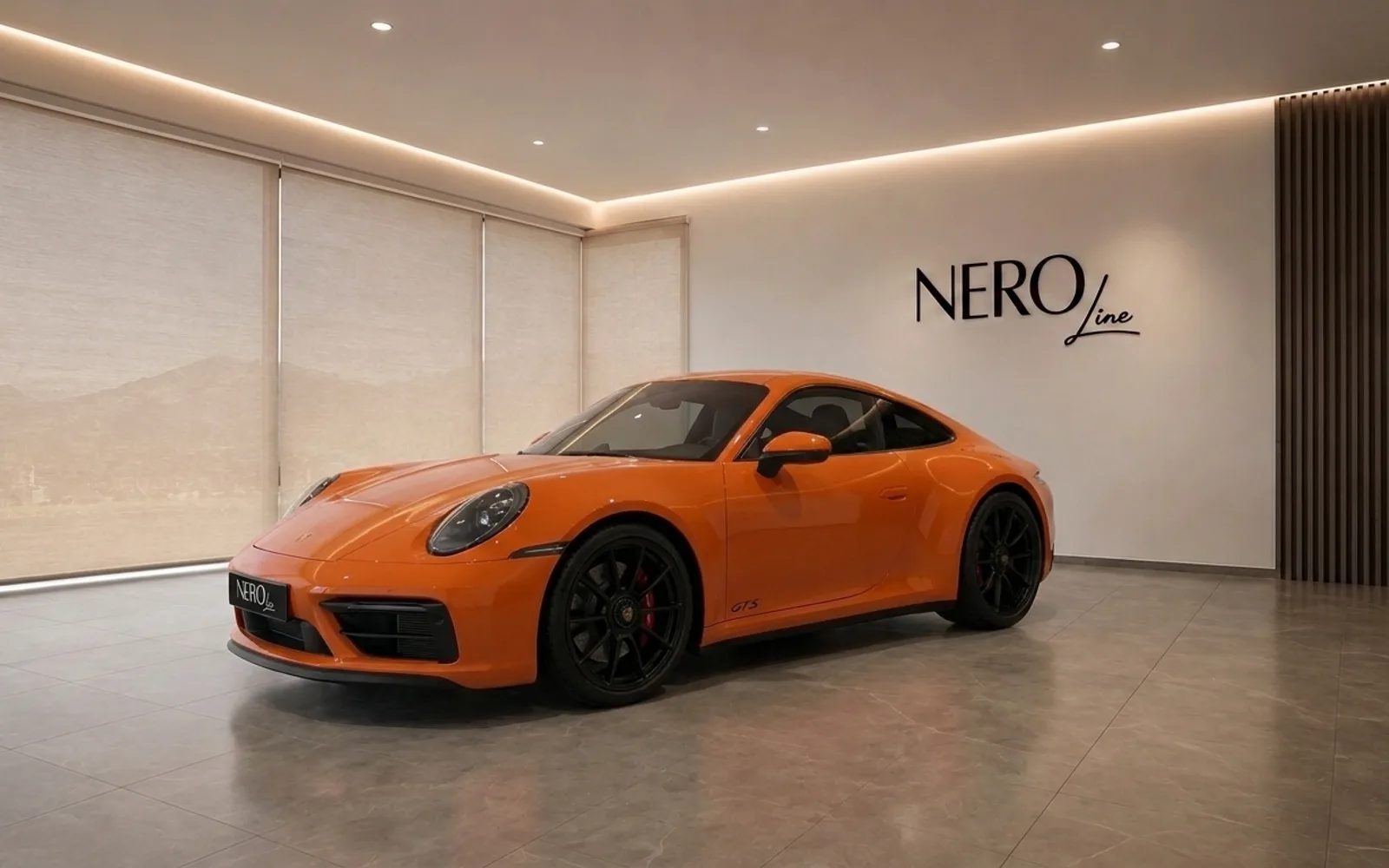 Porsche 911 Carrera 4S — Luxury showroom display The vibrant orange Porsche 911 Carrera 4S is displayed in a modern showroom in Lausanne, showcasing its sleek design.
