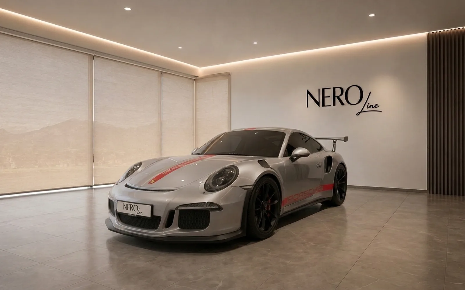 A gloss silver Porsche 911 GT3 RS with red racing stripes, presented from a front three-quarter view in a modern studio in Zurich.