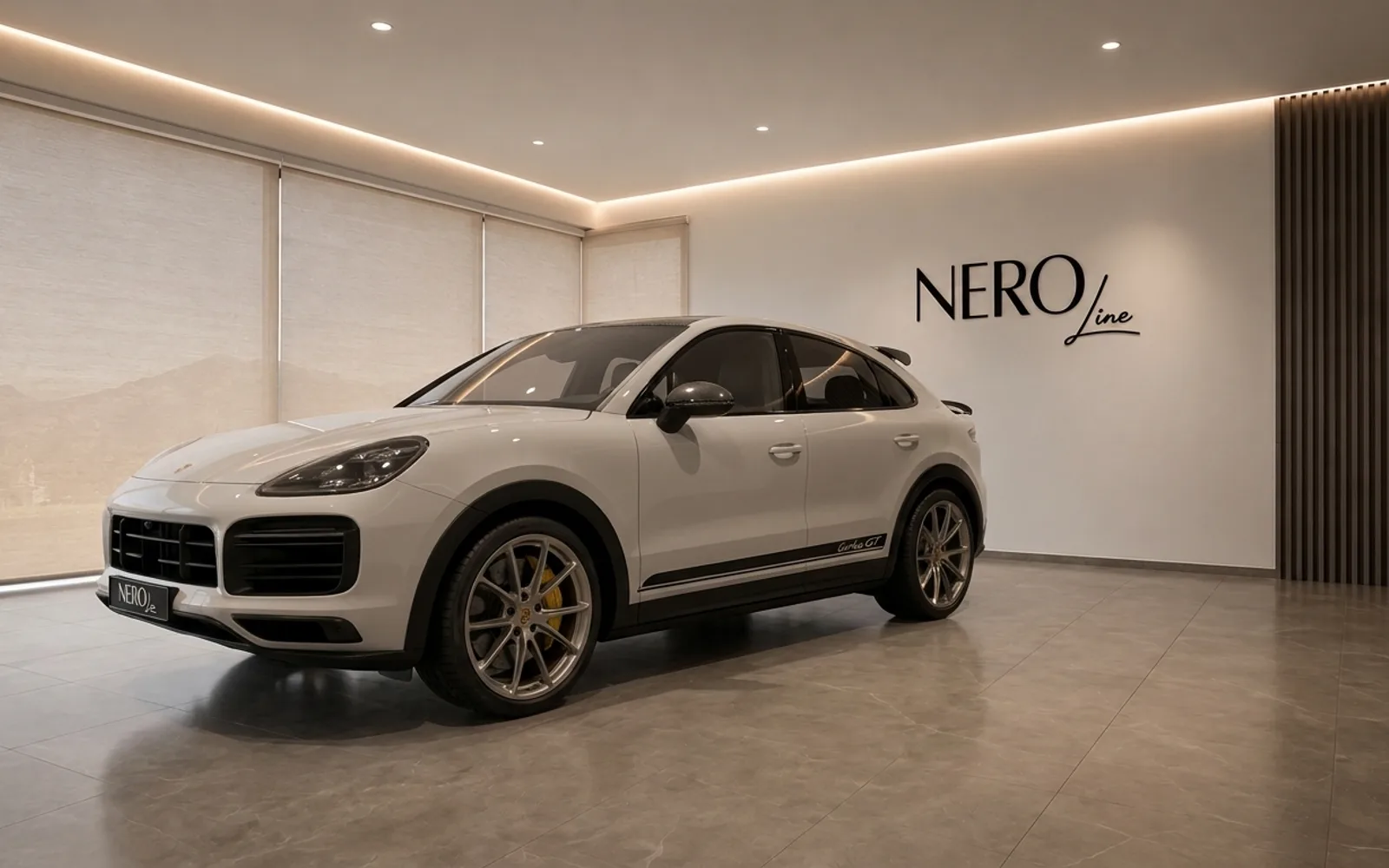 The white Porsche Cayenne Turbo GT is showcased from a front three-quarter view inside the modern Nero Line showroom in Zurich.