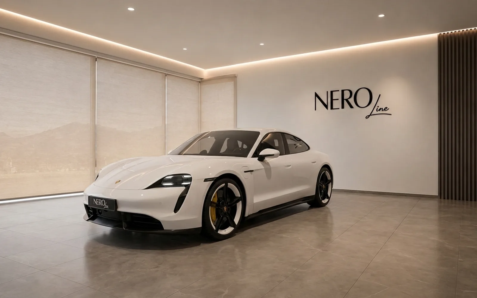 The white Porsche Taycan is showcased from a front three-quarter view in a modern NEROline showroom in Lausanne, with mountain views.