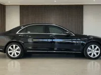 The black Mercedes-Benz S 600 L GUARD is shown in a side profile view, parked in a showroom in Zurich.
