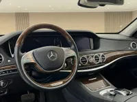 The Mercedes-Benz S 600 L GUARD interior in Zurich, showcasing its luxurious dashboard with wood trim and steering wheel.