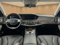 The Mercedes-Benz S 600 L GUARD interior in Zurich, showcasing the luxurious dashboard, wood trim, steering wheel, and front seats.
