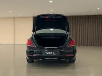 The black Mercedes-Benz S 600 L GUARD is shown from the rear with its trunk open, highlighting its spacious storage in Zurich.