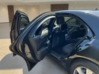 The black Mercedes-Benz S 600 L GUARD in Zurich with its rear passenger door open, revealing the luxurious interior and seatback screens.