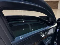 The Mercedes-Benz S 600 L GUARD's armored rear passenger door, showing the tinted window and luxurious interior controls in Zurich.