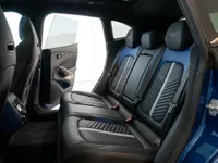 The luxurious rear seats of the Aston Martin DBX707 in Lausanne, featuring blue and black leather upholstery with detailed stitching.