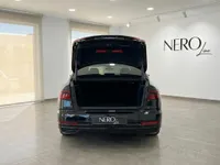 The black Audi A8 L VR10 Armoured car is shown from the rear with its trunk open, in a showroom in Madrid.