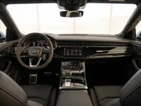 The luxurious interior of the Audi RS Q8 in Lausanne, featuring the detailed dashboard, steering wheel, and front seats.