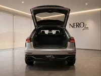 The 2022 Audi RS Q8 in Gloss metallic Florett Silver Metallic, showcasing its spacious open trunk from the rear in Lausanne.