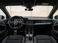 The luxurious interior of the 2023 Audi RS3 Performance Edition in Zurich, featuring its advanced dashboard, steering wheel, and comfortable front seats.