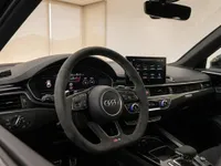 The luxurious interior of the 2024 Audi RS4 Avant in Zurich, showcasing the Alcantara steering wheel, digital cockpit, and central infotainment screen.