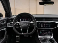 The modern cockpit of the 2023 Audi RS6 Avant, featuring the steering wheel, digital displays, and central console in Lausanne.