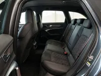 The luxurious black leather rear seats with red stitching and 'RS' logo of the Audi RS6 Avant Performance in Lausanne.