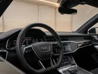 The luxurious interior of the Audi RS6 Avant Performance in Zurich, featuring the steering wheel, digital dashboard, and infotainment screen.