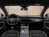 The luxurious cockpit of the Audi RS6 Avant Performance in Zurich, featuring its advanced dashboard, steering wheel, and sport seats.