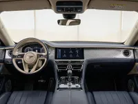 The luxurious interior cockpit of the 2023 Bentley Flying Spur, featuring blue leather and a beige steering wheel, available in Lausanne.