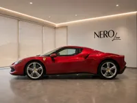 The red Ferrari 296 GTB is parked sideways in a modern showroom with the Nero Line logo in Lausanne.