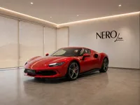 The striking red Ferrari 296 GTS is showcased from a front three-quarter view in a modern NEROline showroom in Zurich.