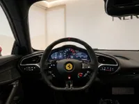 The luxurious cockpit of the Ferrari 296 GTS in Zurich, showcasing its carbon fiber steering wheel and digital dashboard.