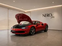 The striking red Ferrari 296 GTS is showcased from the front with its frunk open inside a modern NEROline showroom in Zurich.