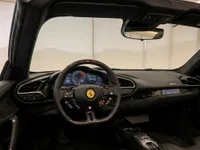 The luxurious cockpit of the blue Ferrari 296 GTS in Zurich, featuring its advanced digital dashboard and multifunction steering wheel.