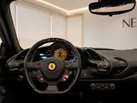 The luxurious cockpit of the Ferrari 488 Spider in Zurich, featuring its distinctive steering wheel, dashboard, and instrument cluster.