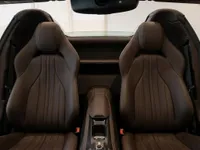The luxurious brown leather seats and center console of the Ferrari 812 GTS interior in Lausanne.