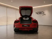 The gloss Rosso Corsa Red Ferrari 812 Superfast is seen from the rear with its trunk open in a showroom in Lausanne.