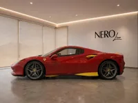 The red Ferrari F8 Spider is showcased in a modern showroom with the NEROline logo, viewed from its side profile in Zurich.
