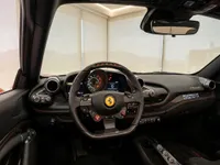 The luxurious cockpit and dashboard of the Ferrari F8 Spider are visible, showcasing its advanced controls in Zurich.