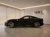 The black Ferrari Portofino luxury car is displayed in a showroom with the NEROline logo in Zurich.