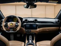 The luxurious interior of the Ferrari Portofino in Zurich, showcasing its tan and black dashboard, steering wheel, and central console.