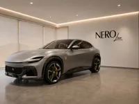 The 2023 Ferrari Purosangue in satin silver-grey, showcased from a front three-quarter angle in a modern showroom in Lausanne.