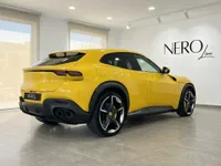 ジアッロモデナの黄色いフェラーリプロサングエが、アリカンテのショールーム内で後方斜めから展示されています。