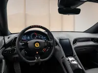The luxurious interior of the 2022 Ferrari Roma in Lausanne, showcasing the driver's cockpit with its advanced digital dashboard and central infotainment screen.