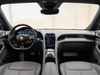 Ferrari Roma's luxurious interior, featuring the steering wheel, digital dashboard, and central console, available for rental in Lausanne.