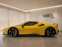 The yellow Ferrari SF90 Spider is showcased in a showroom, displaying its sleek side profile in Zurich.