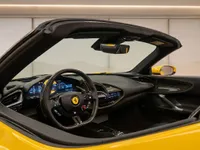 The luxurious cockpit and dashboard of the yellow Ferrari SF90 Spider are visible from the passenger side in Zurich.