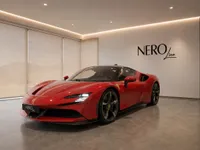 The red Ferrari SF90 Stradale supercar is prominently displayed in a modern showroom in Lausanne, showcasing its sleek front three-quarter view.