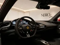 The luxurious interior of the Ferrari SF90 Stradale in Lausanne, showcasing its advanced digital cockpit and steering wheel.