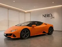 Matte orange Lamborghini Huracán EVO Spyder parked indoors, showcasing its sleek front three-quarter view in Zurich.