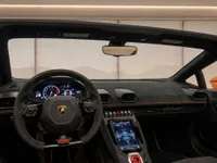 The interior of the Lamborghini Huracán EVO Spyder in Zurich, featuring its steering wheel, digital dashboard, and central console.